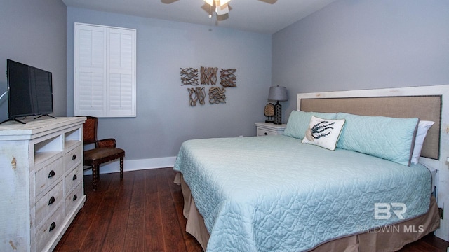 bedroom with dark wood-type flooring, baseboards, and a ceiling fan