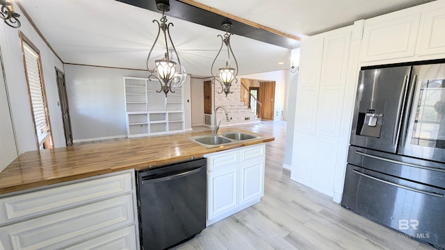 kitchen with white cabinetry, sink, hanging light fixtures, stainless steel appliances, and wooden counters