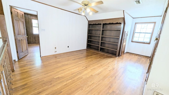 unfurnished bedroom with ceiling fan, light hardwood / wood-style floors, and ornamental molding