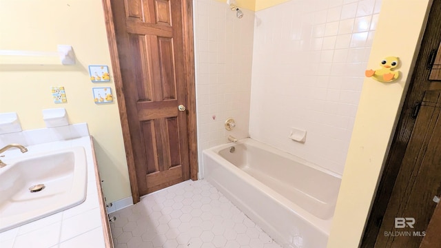 bathroom with tile patterned flooring, vanity, and tiled shower / bath