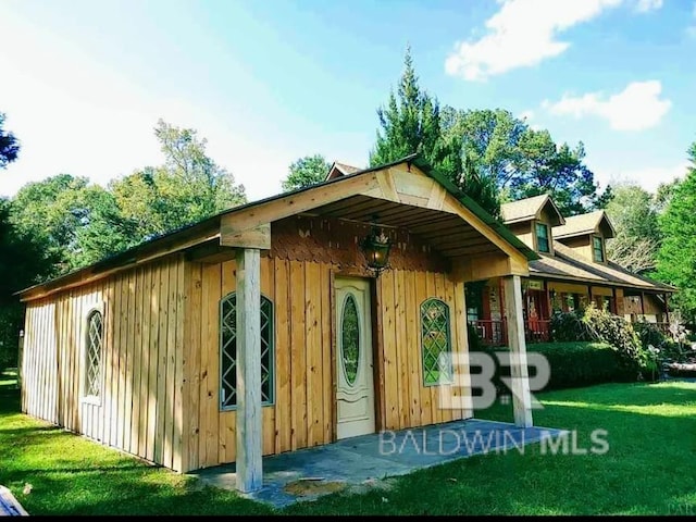 view of outbuilding with a yard