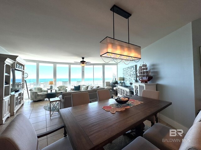 28107 Perdido Beach Blvd Unit D713, Orange Beach, AL 36561 - dining area with a water view, baseboards, floor to ceiling windows, light tile patterned flooring, and a ceiling fan