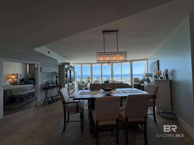 28107 Perdido Beach Blvd Unit D713, Orange Beach, AL 36561 - dining area featuring baseboards, floor to ceiling windows, and dark tile patterned flooring
