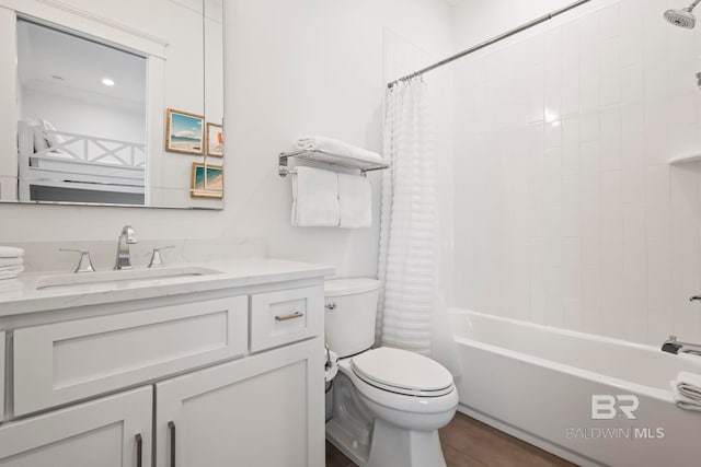 full bathroom featuring vanity, shower / bath combo with shower curtain, and toilet