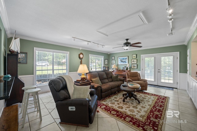 living room featuring french doors, ceiling fan, ornamental molding, and light tile patterned flooring