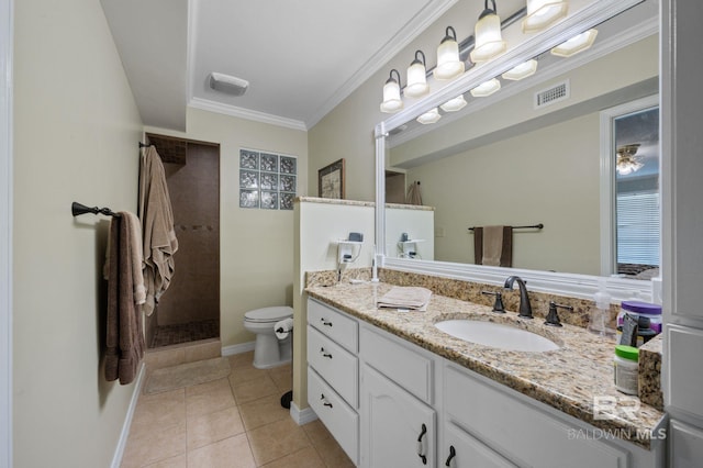 bathroom featuring ornamental molding, vanity, tiled shower, tile patterned flooring, and toilet