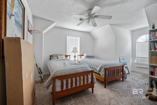 carpeted bedroom featuring multiple windows, a textured ceiling, ceiling fan, and lofted ceiling