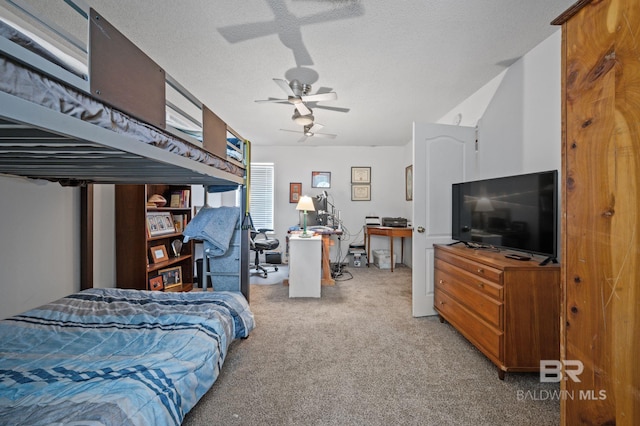 carpeted bedroom featuring ceiling fan and a textured ceiling