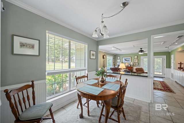 tiled dining area featuring ceiling fan with notable chandelier, track lighting, and ornamental molding