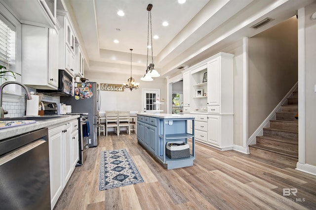 10197 Bellingrath Rd, Theodore, AL 36582 - kitchen featuring stainless steel appliances, open shelves, blue cabinets, white cabinetry, and recessed lighting