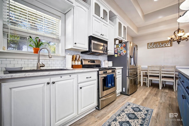 10197 Bellingrath Rd, Theodore, AL 36582 - kitchen featuring stainless steel appliances, white cabinets, tasteful backsplash, and glass insert cabinets