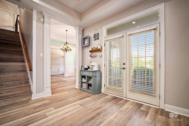 10197 Bellingrath Rd, Theodore, AL 36582 - entrance foyer with wood finished floors, stairway, a chandelier, a decorative wall, and decorative columns