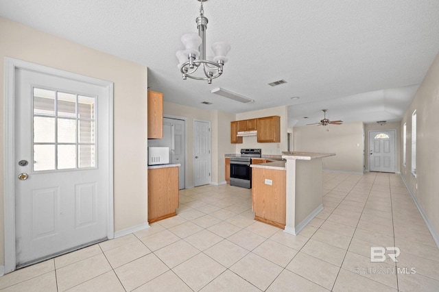 kitchen featuring stainless steel range with electric stovetop, ceiling fan with notable chandelier, light tile patterned floors, decorative light fixtures, and kitchen peninsula