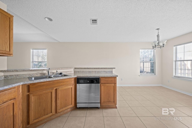 kitchen featuring dishwasher, sink, hanging light fixtures, light tile patterned floors, and a chandelier