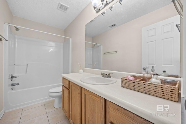 full bathroom with shower / bath combination, vanity, a textured ceiling, tile patterned flooring, and toilet