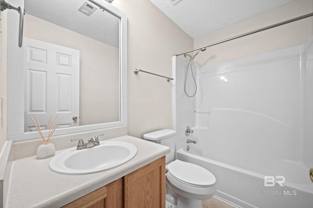 full bathroom with vanity, toilet, a textured ceiling, and shower / washtub combination