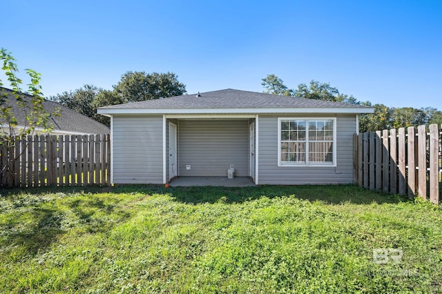 back of property with a lawn