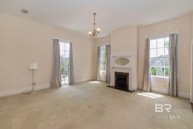 unfurnished living room featuring light colored carpet and a wealth of natural light