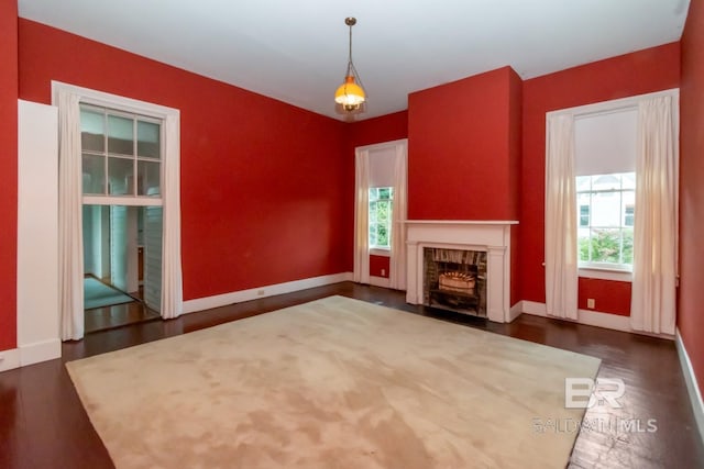 unfurnished living room with dark hardwood / wood-style flooring