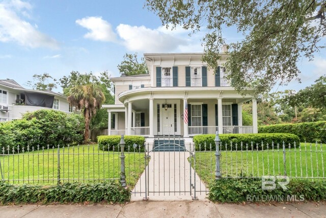 italianate house featuring a front yard and covered porch