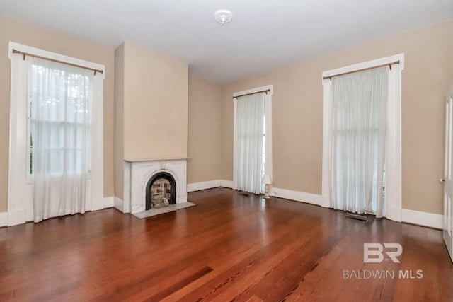 unfurnished living room with wood-type flooring