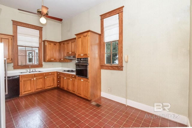 kitchen featuring sink, black appliances, ceiling fan, and dark tile patterned flooring