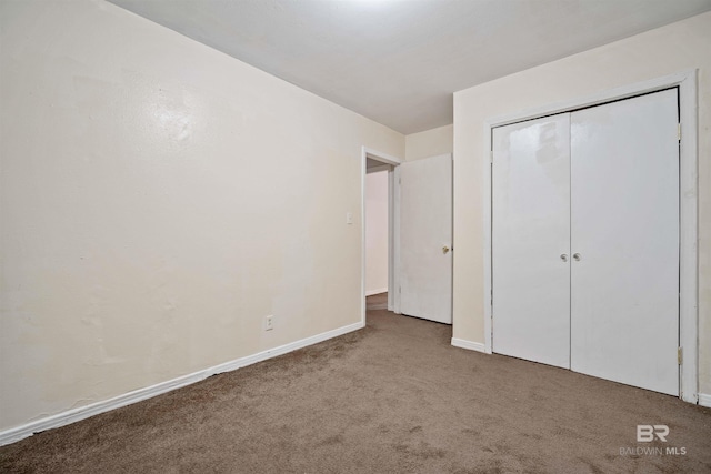 unfurnished bedroom with carpet floors and a closet