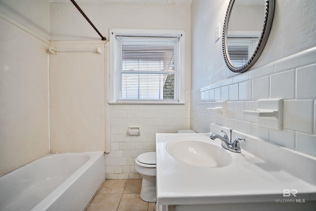 full bathroom featuring vanity, tile patterned floors, washtub / shower combination, toilet, and tile walls