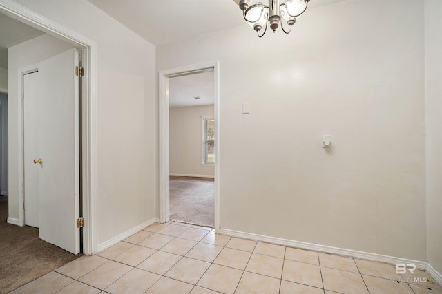 interior space featuring light carpet and a notable chandelier