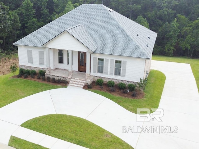 modern farmhouse featuring a front yard and a porch