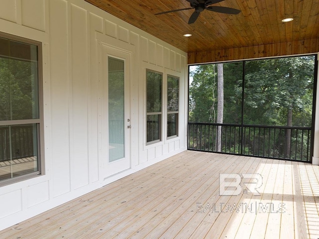 unfurnished sunroom featuring ceiling fan and wooden ceiling