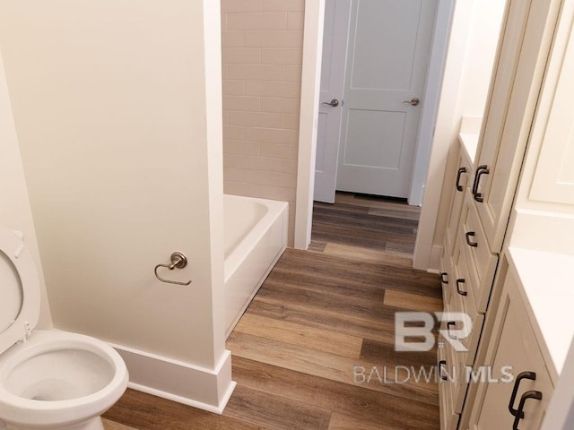 bathroom featuring hardwood / wood-style floors, vanity, and toilet