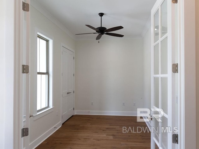 spare room featuring ceiling fan, dark hardwood / wood-style floors, and ornamental molding