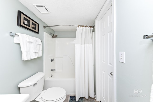 full bathroom featuring visible vents, a textured ceiling, shower / tub combo, and toilet
