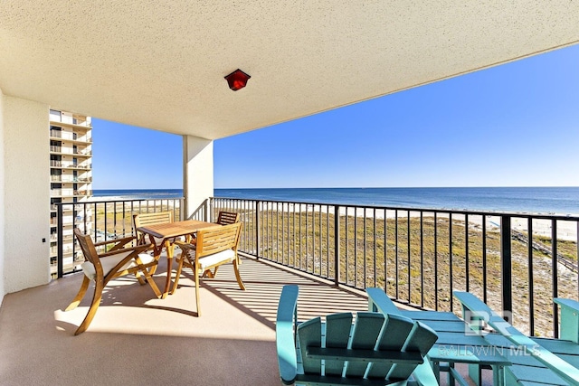 balcony with a view of the beach and a water view