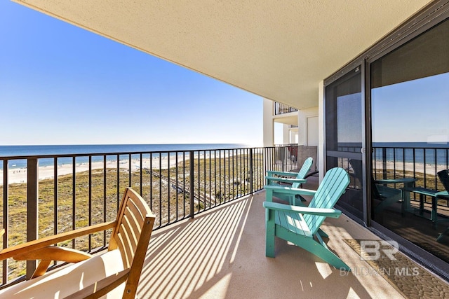 balcony with a beach view and a water view