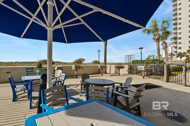 view of patio featuring fence and outdoor dining space