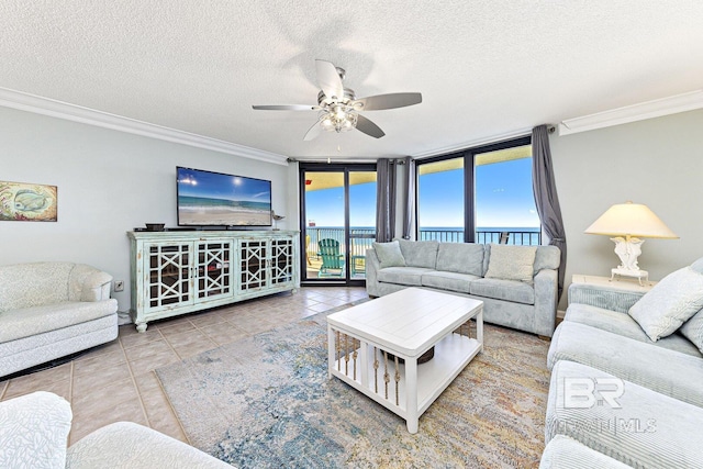 living area featuring a textured ceiling, ceiling fan, ornamental molding, and tile patterned flooring
