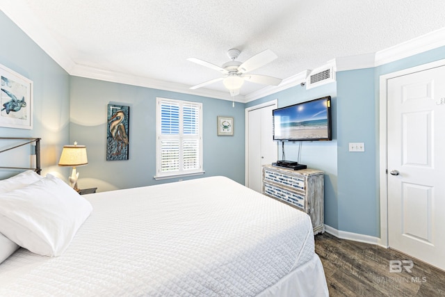bedroom with crown molding, baseboards, dark wood-style flooring, and visible vents