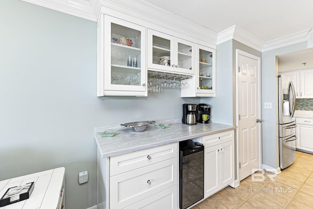 bar featuring a textured ceiling, light tile patterned floors, stainless steel fridge with ice dispenser, wine cooler, and ornamental molding