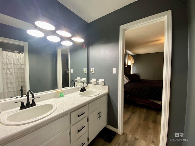 bathroom featuring wood-type flooring, a textured ceiling, and vanity