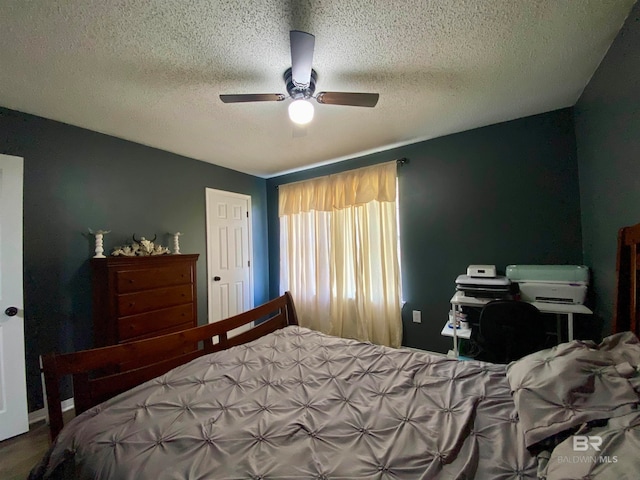 bedroom with a textured ceiling and ceiling fan