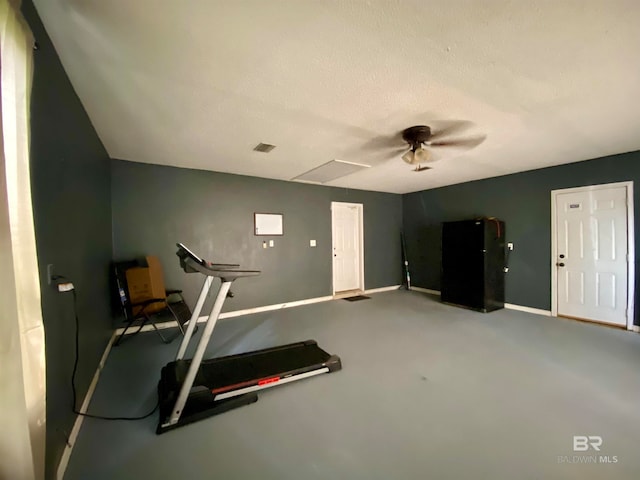 exercise room featuring concrete floors and a textured ceiling