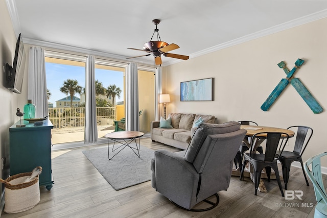 living room with light wood-type flooring, ceiling fan, and crown molding