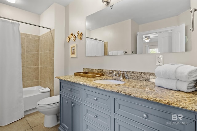 full bathroom featuring ceiling fan, tile patterned flooring, toilet, vanity, and shower / tub combo