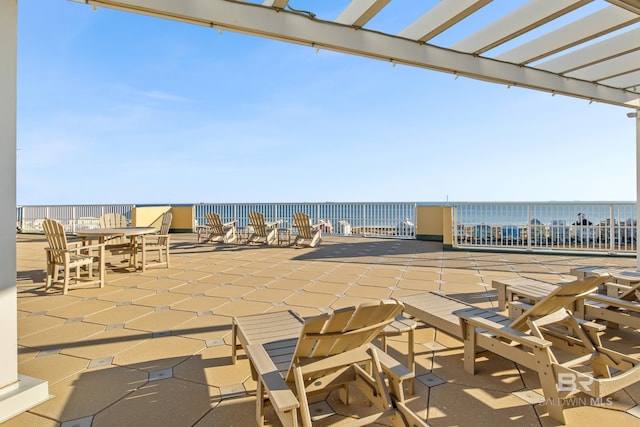 view of patio / terrace featuring a water view and a pergola