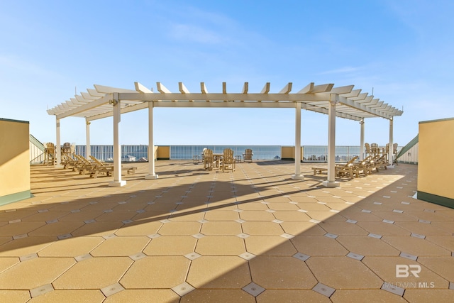 view of patio / terrace with a water view and a pergola