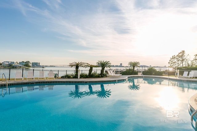 view of swimming pool featuring a water view