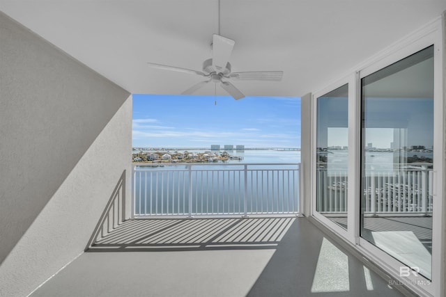 balcony with a water view and ceiling fan