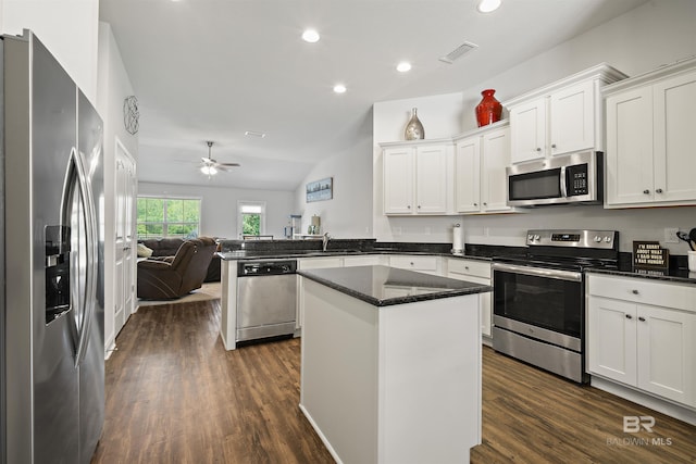 kitchen with appliances with stainless steel finishes, open floor plan, white cabinets, ceiling fan, and recessed lighting
